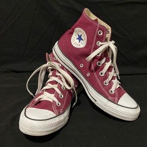 Woman’s burgundy converse high tops